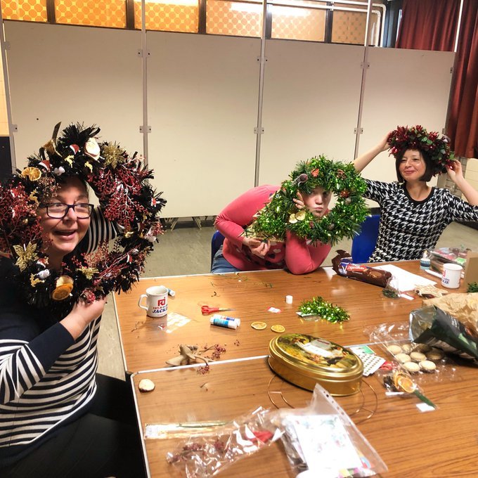 Caseworker Pippa and members at Craftivism and Chat making Christmas Wreathes 